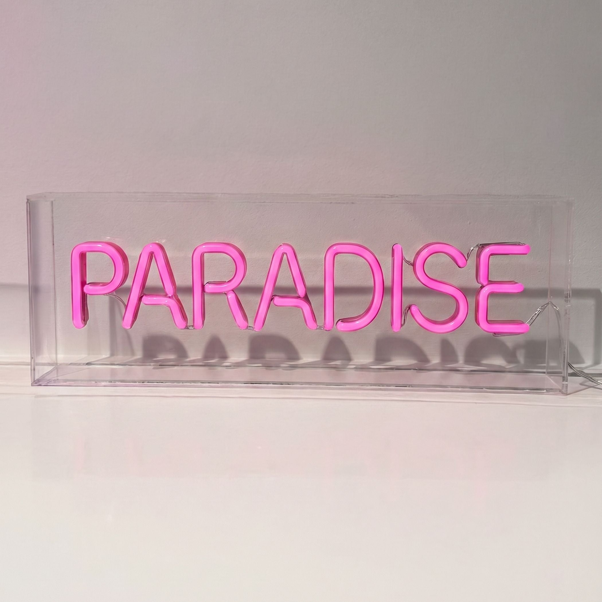 Paradise pink LED neon sign in clear acrylic box — tabletop decor designed in Dubai UAE